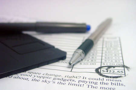 Financial document with pens and a floppy disk
