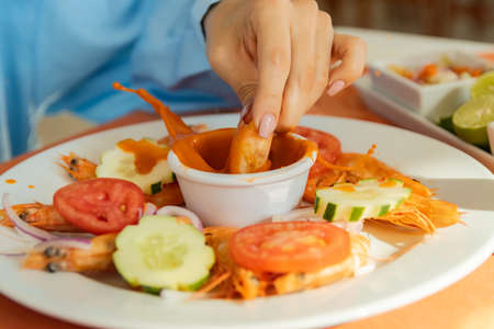 Slow Motion Shrimp dunked in red salsa mexican seafood delicious