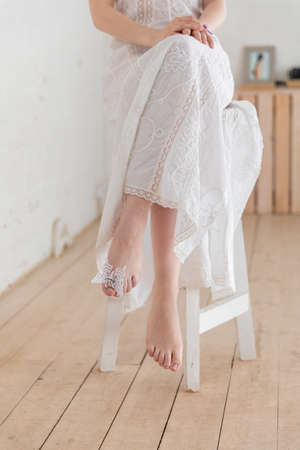 Girl on a chair with an artificial butterfly on his fingerの写真素材