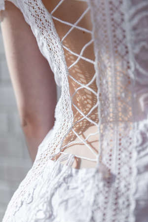 Spin girl in a white dress with lacingの写真素材