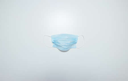 Blue facial mask isolated on white background. Protect against coronavirus (COVID-19) concept....