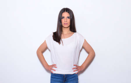 Portrait of confident and beautiful young woman looking to the front. Girl isolated on white...