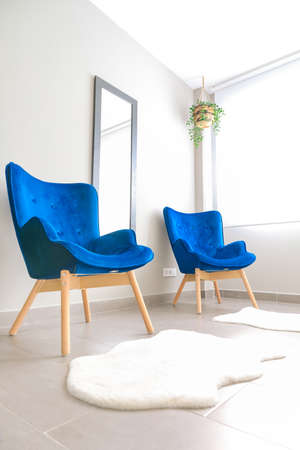 Modern flat interior with two blue armchairsの写真素材