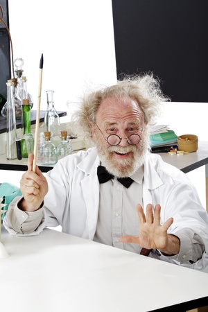 Enthusiastic eccentric senior scientist in his lab points up excited about ideas. High key, vertical, copy space.の写真素材