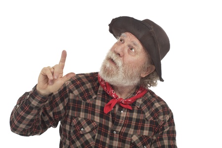 Old west cowboy with battered felt hat and whiskers looks up and points. Isolated on white, horizontal, copy space.の写真素材