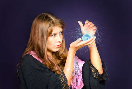 The girl looks into the crystal ball の写真素材