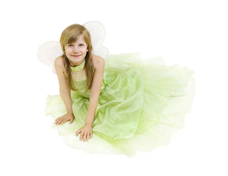 Girl dressed as a fairy sitting on the floorの写真素材