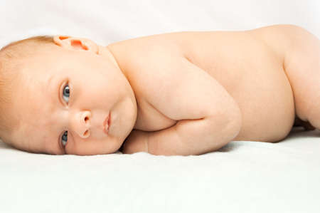 The child lies on his belly