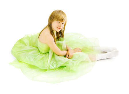 Girl in a magnificent dress sitting on the floorの写真素材