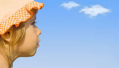 The girl looks into the distancea, gainst the blue sky の写真素材