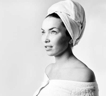 The young woman in a towel, a white backgroundの写真素材