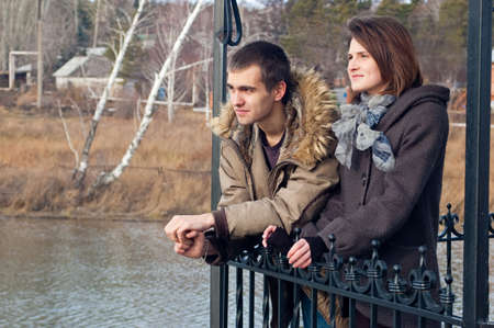 Young guy and the girl stand in an arbourの写真素材