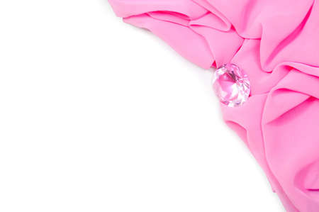 Pink fabric with a precious stone, a white backgroundの写真素材