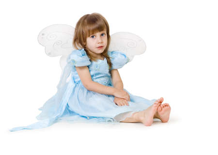 The girl in a dress sits on a floorの写真素材