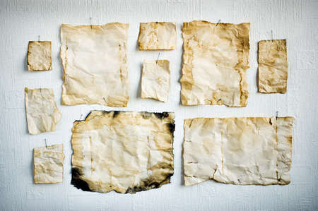 Sheet of old paper pinned to the wallの写真素材