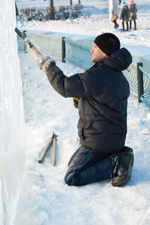 Man carves patterns in the ice slabの写真素材