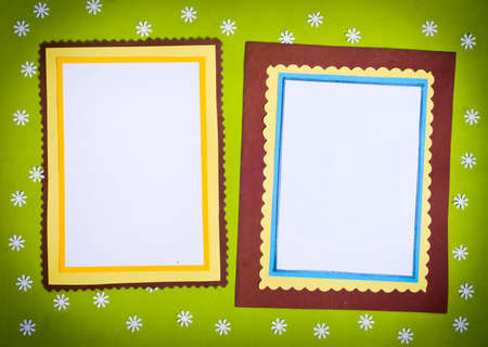 Frame made  of paper on a green background