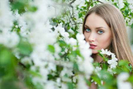 Beautiful woman in spring flowersの写真素材
