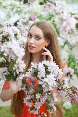 Beautiful woman in spring flowersの写真素材