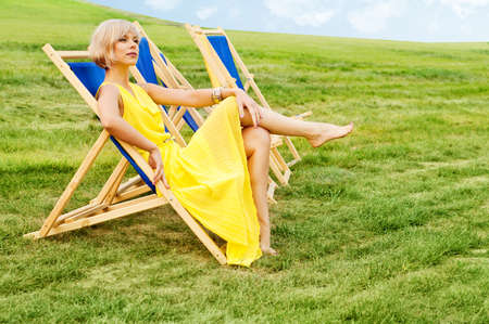 Woman relaxing in a lounge chair