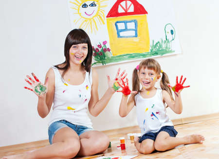 Woman and child have fun paint colorsの写真素材