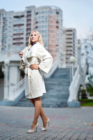 A girl in a white coat,
in cityの写真素材