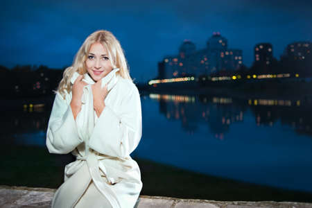 A girl in a white coat, nightの写真素材