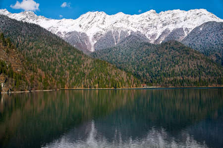 snow-capped mountains reflected in a lakeの写真素材