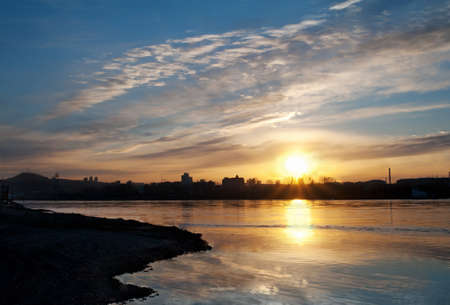 Sunset view of the city on the riverの写真素材