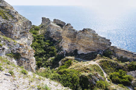 beautiful rocky sea coast under blue skyの写真素材
