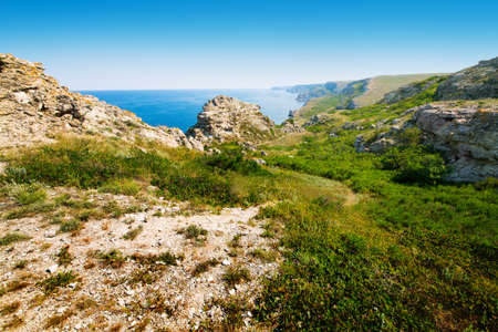 beautiful rocky sea coast under blue skyの写真素材