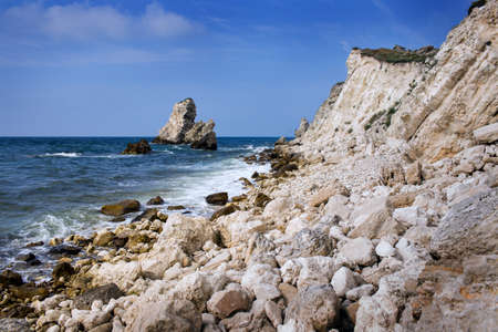 beautiful rocky sea coast under blue skyの写真素材