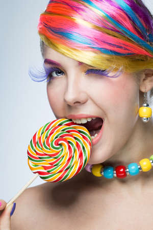 woman with bright makeup and candy の写真素材