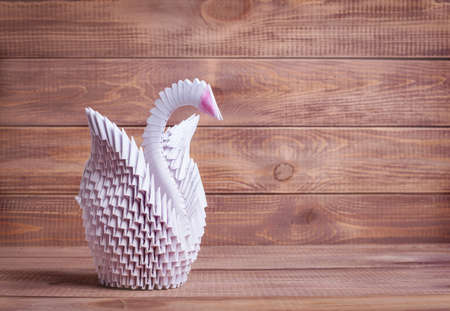 Modular origami swan out on a wooden backgroundの写真素材