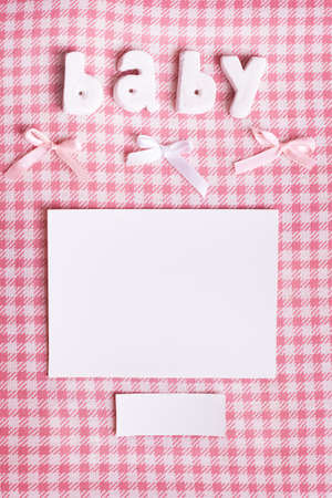 word baby and  card on plaid  backgroundの写真素材