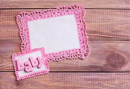 Napkins with pink lace on the wooden background の写真素材