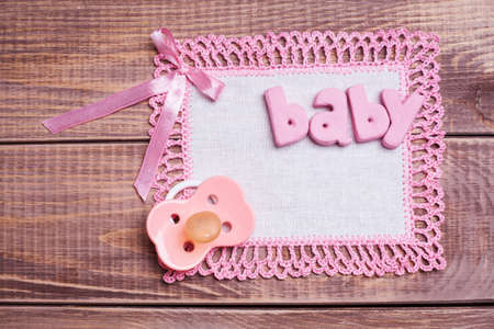 Dummy with napkin and pink lace on the wooden background の写真素材