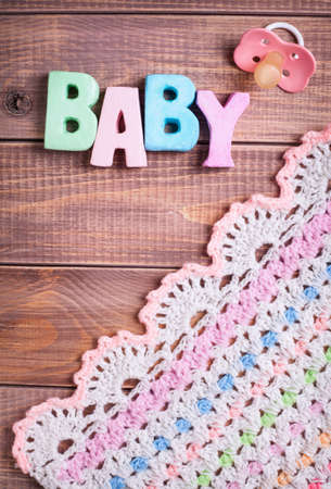 Word baby and nipple on a wooden background の写真素材