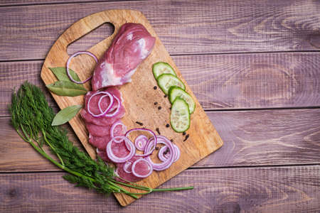 Sliced ââraw meat pork on boardの写真素材