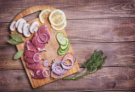 Sliced ââraw meat pork on boardの写真素材