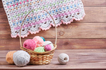 Balls of colored yarn on wooden boardsの写真素材