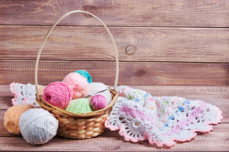 Balls of colored yarn on wooden boardsの写真素材