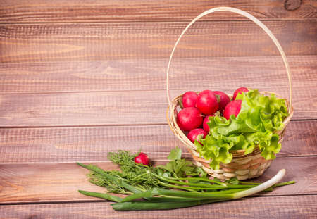 basket of radishes on wooden boardsの写真素材