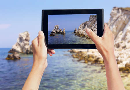 photo shooting on tablet pc at coast seaの写真素材