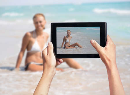 photo shooting on tablet pc of womanの写真素材