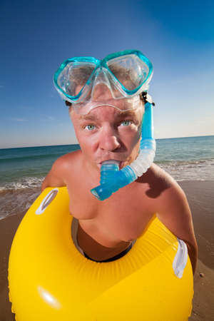 man in flippers and mask on the bank of the seaの写真素材