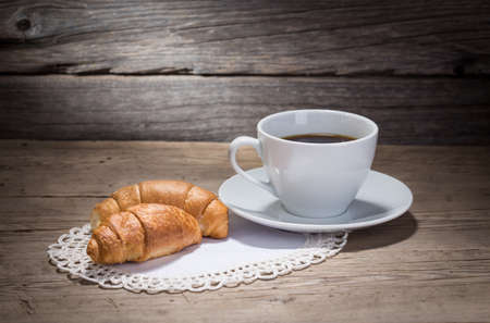 warm cup of coffee on wooden backgroundの写真素材