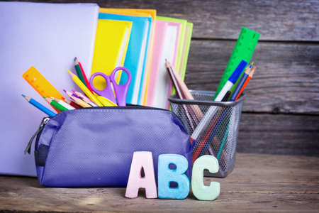 school supplies labeled ABC on a wooden background