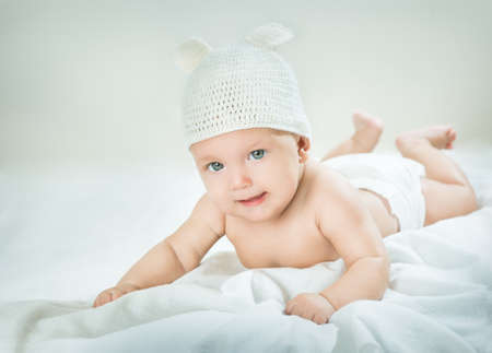 baby in a white hat on a white backgroundの写真素材