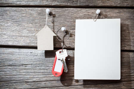 paper and keys on wooden background の写真素材